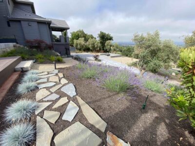 front entrance with flagstone and mulched flower garden